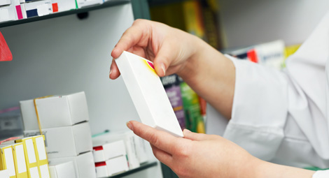 Pharmacist holding a packet of medicine